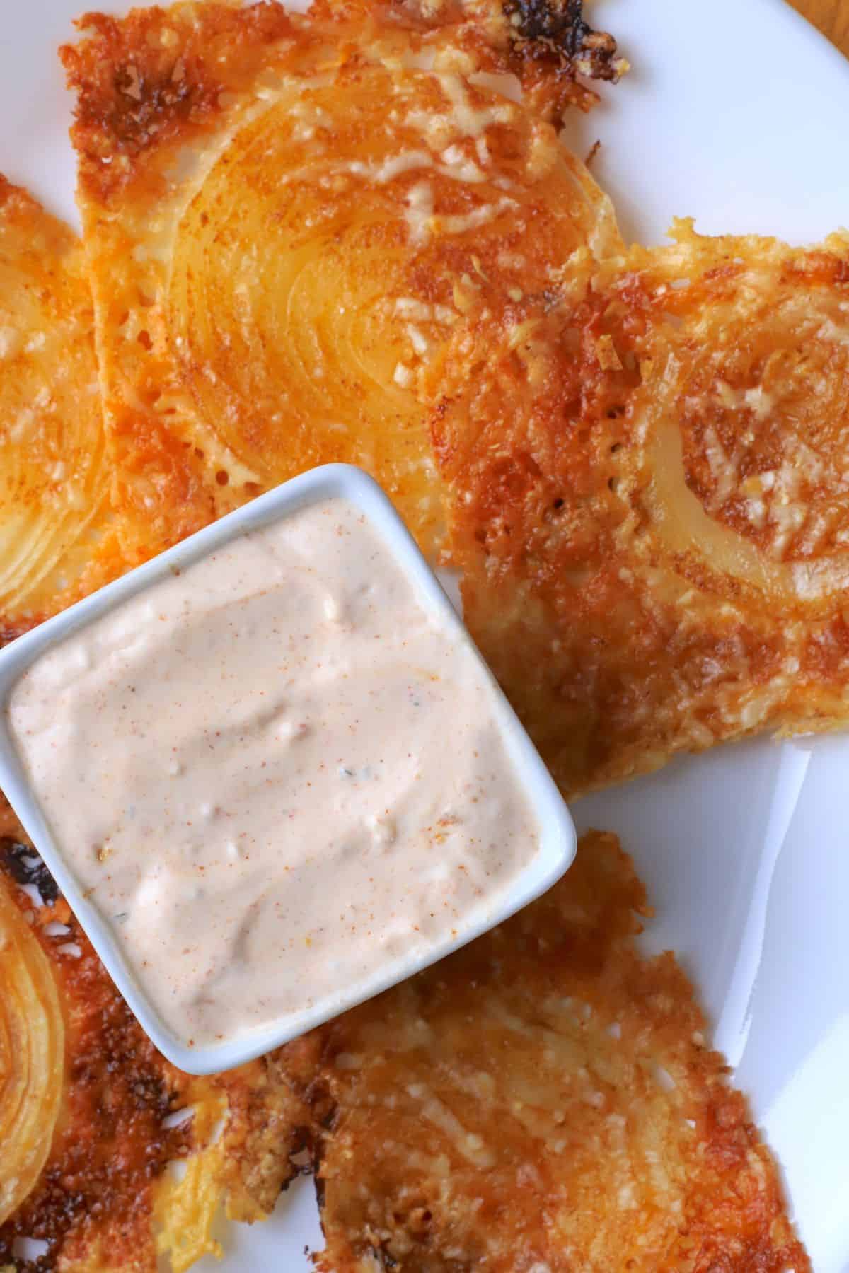 2 ingredient onion ring chips on a plate with a dip.