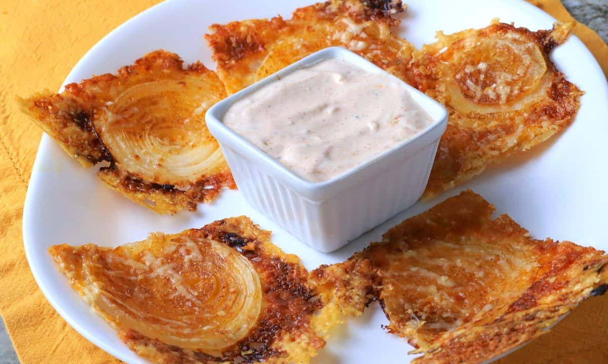 2 ingredient onion ring chips on a plate with a dip.