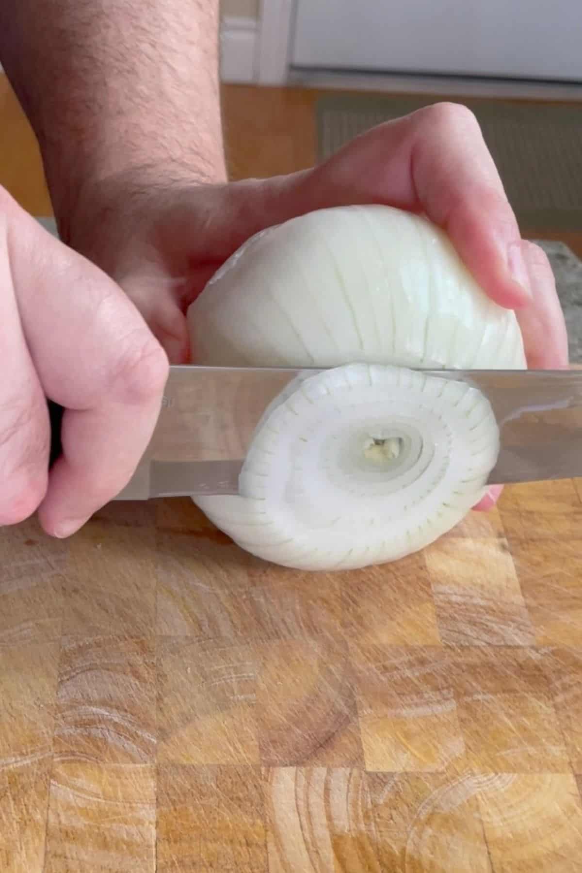 Slicing onions on a cutting board.